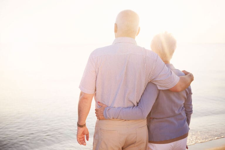 Featured image for Veteran Spouse Benefits showing a Veteran and his spouse standing arm by arm