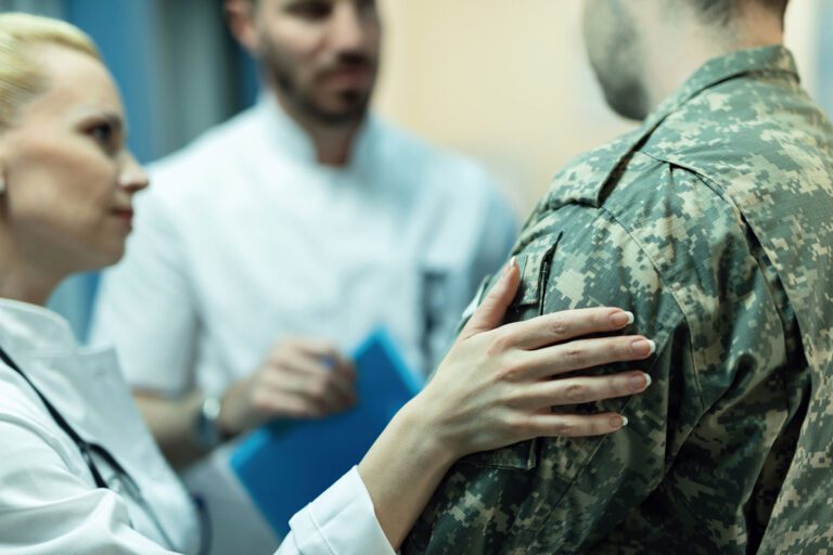 Featured image for PACT Act showing a female doctor consoling a Veteran