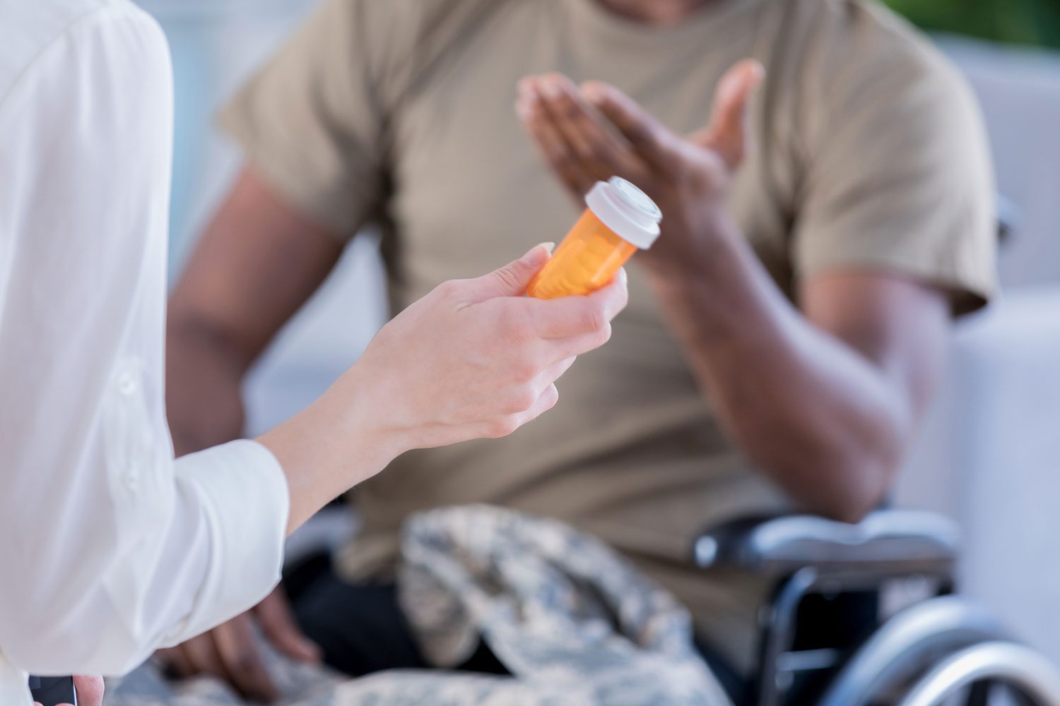 Featured image for VA Health Care showing a female doctor giving medication to a Veteran in a wheelchair