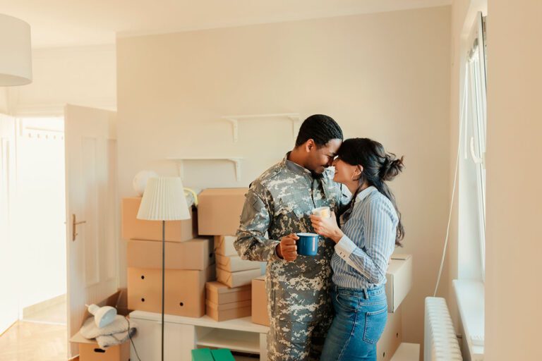 Featured image for VA Home Loans showing a male Servicemember and his wife moving into their new home