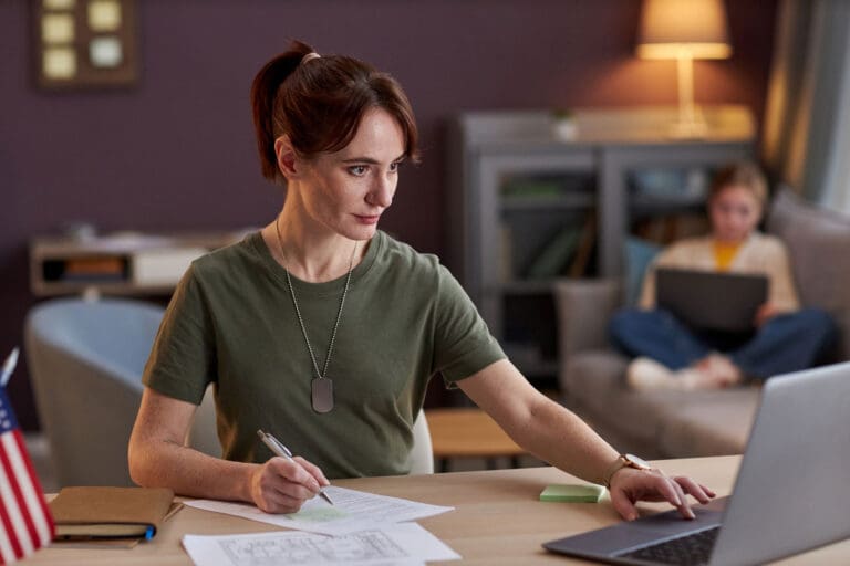 Featured image for Post-9/11 GI Bill Chapter 33, showing a female Servicemember studying at home