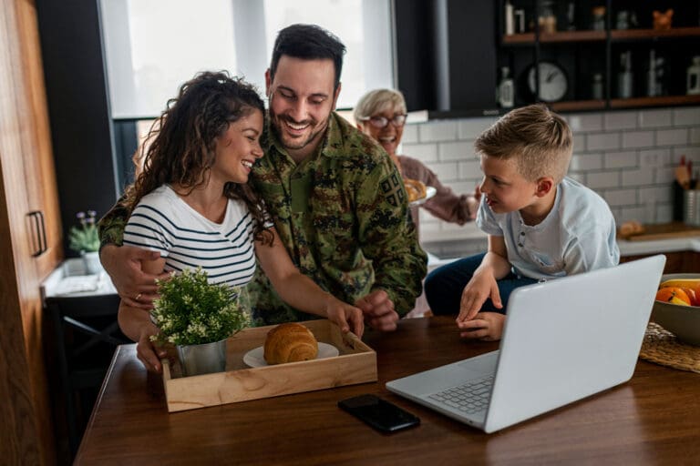 Featured image for GI Bill Transferability, showing a happy military family in their kitchen