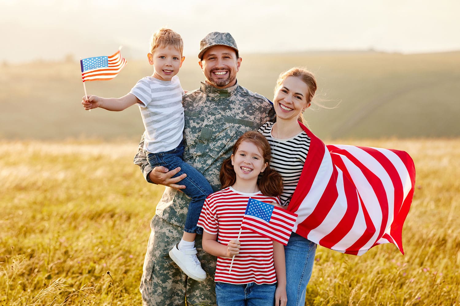 Featured image for Service Members Group Life Insurance – also called SGLI – showing a happy military family with flags of the United States