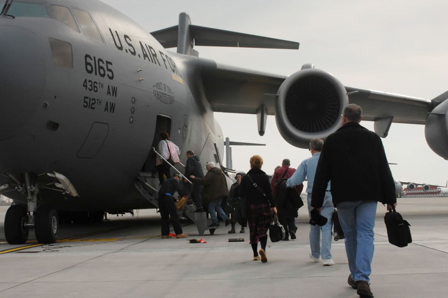 Featured image for Space-A travel, showing military personnel, Veterans, and their families boarding a military Space-A flight.