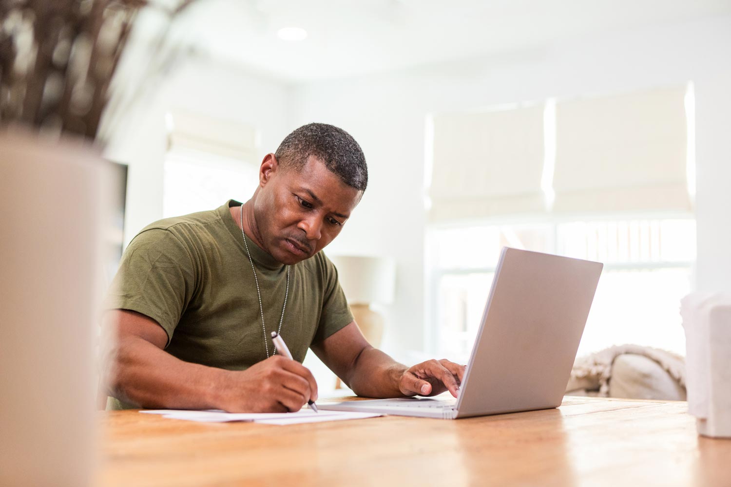 Featured image for Chapter 30 GI Bill – also called Montgomery GI Bill for Active Duty – showing a Servicemember studying on his laptop