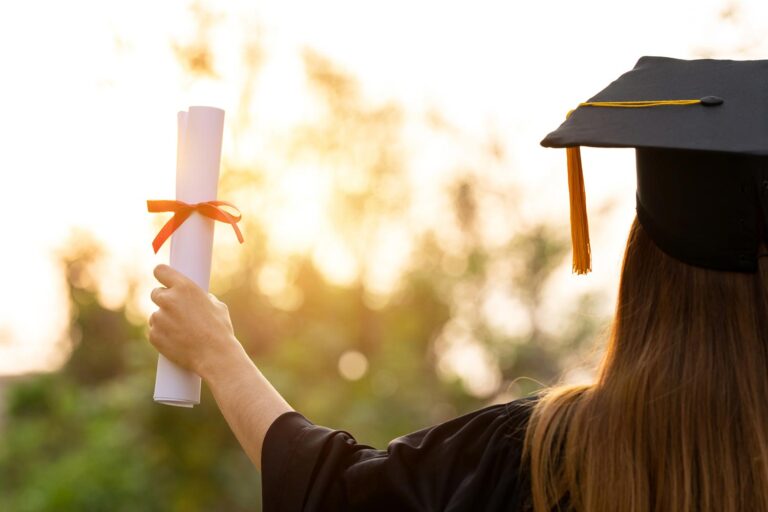 Featured image for Fry Scholarship, showing a dependent of a Servicemember who died, graduating with a diploma in their hand