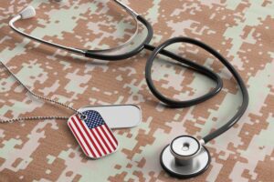 Featured image for TRICARE for Active Duty, showing a stethoscope and a military dog tag with a flag of the United States