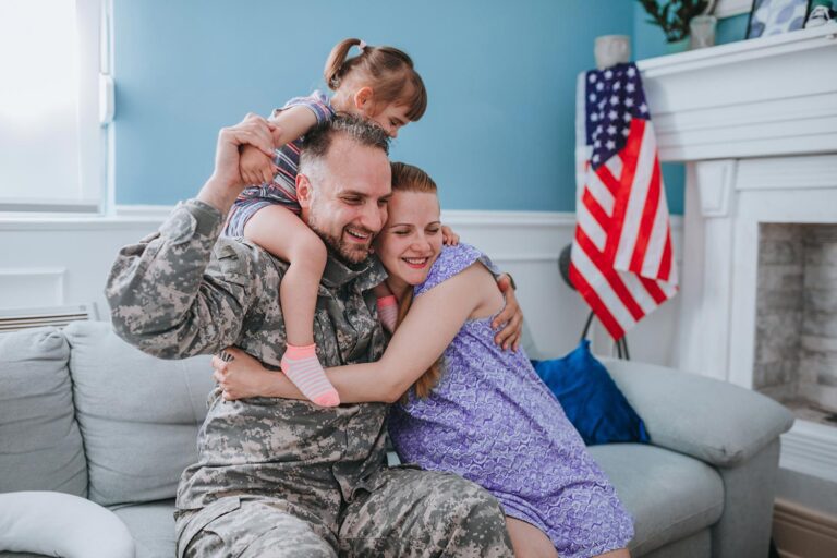 Featured image for TRICARE for Dependents, showing a happy military family in their living room