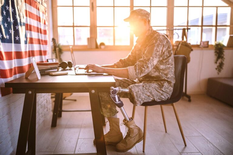 Featured image for Veteran Readiness and Employment – also called VR&E – showing a disabled Veteran working on his laptop